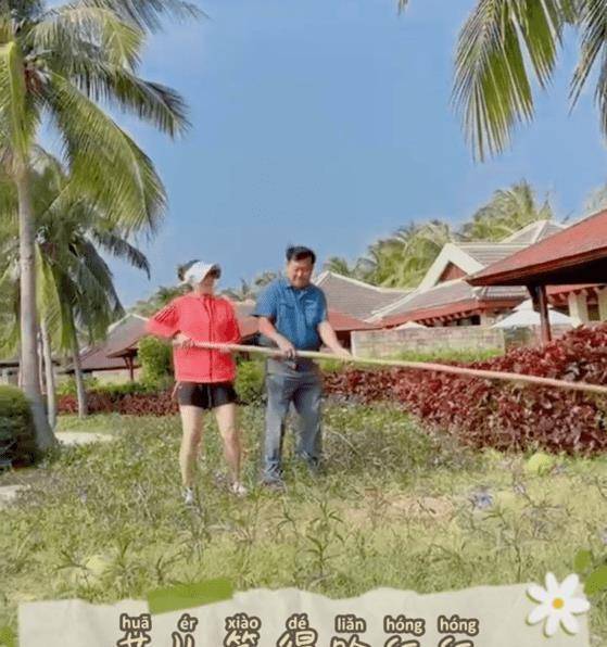 原创48岁孙悦曝近况长竹竿摘椰子暴露修长美腿身旁男子身份成谜