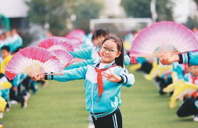 柳城縣實驗小學總部,學生在課間操時段跳起彩調操.