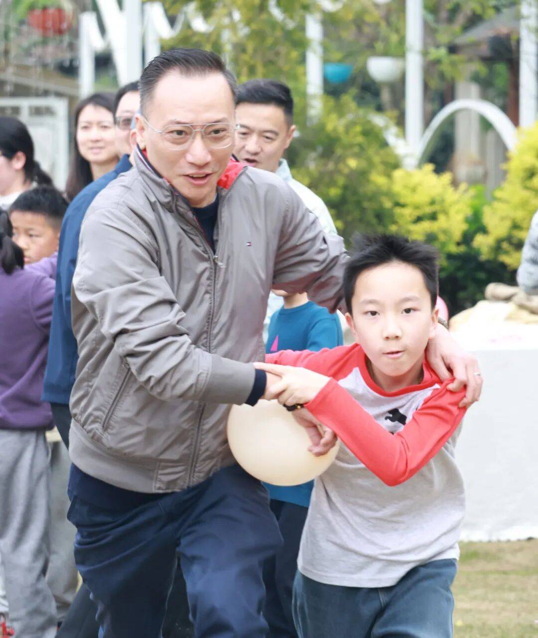 只见孩子们和爸爸妈妈们小心翼翼地夹着球像两只可爱的螃蟹横着走
